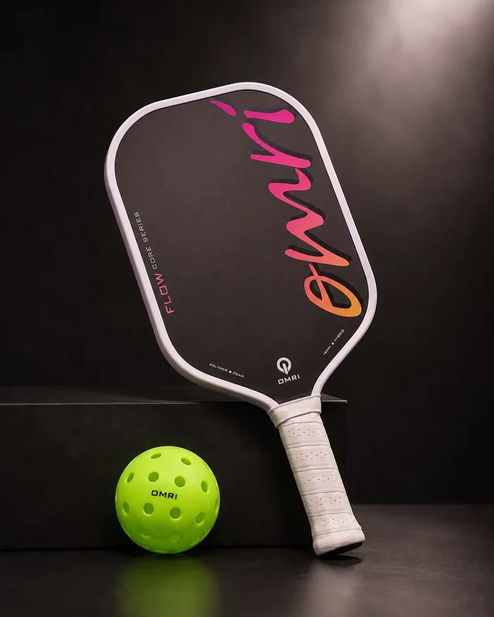OMRI FLOW SUNSET pickleball paddle with ball, studio shot